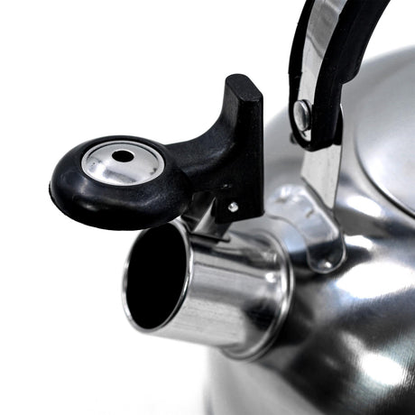 A stainless steel whistling camping kettle on a stove.