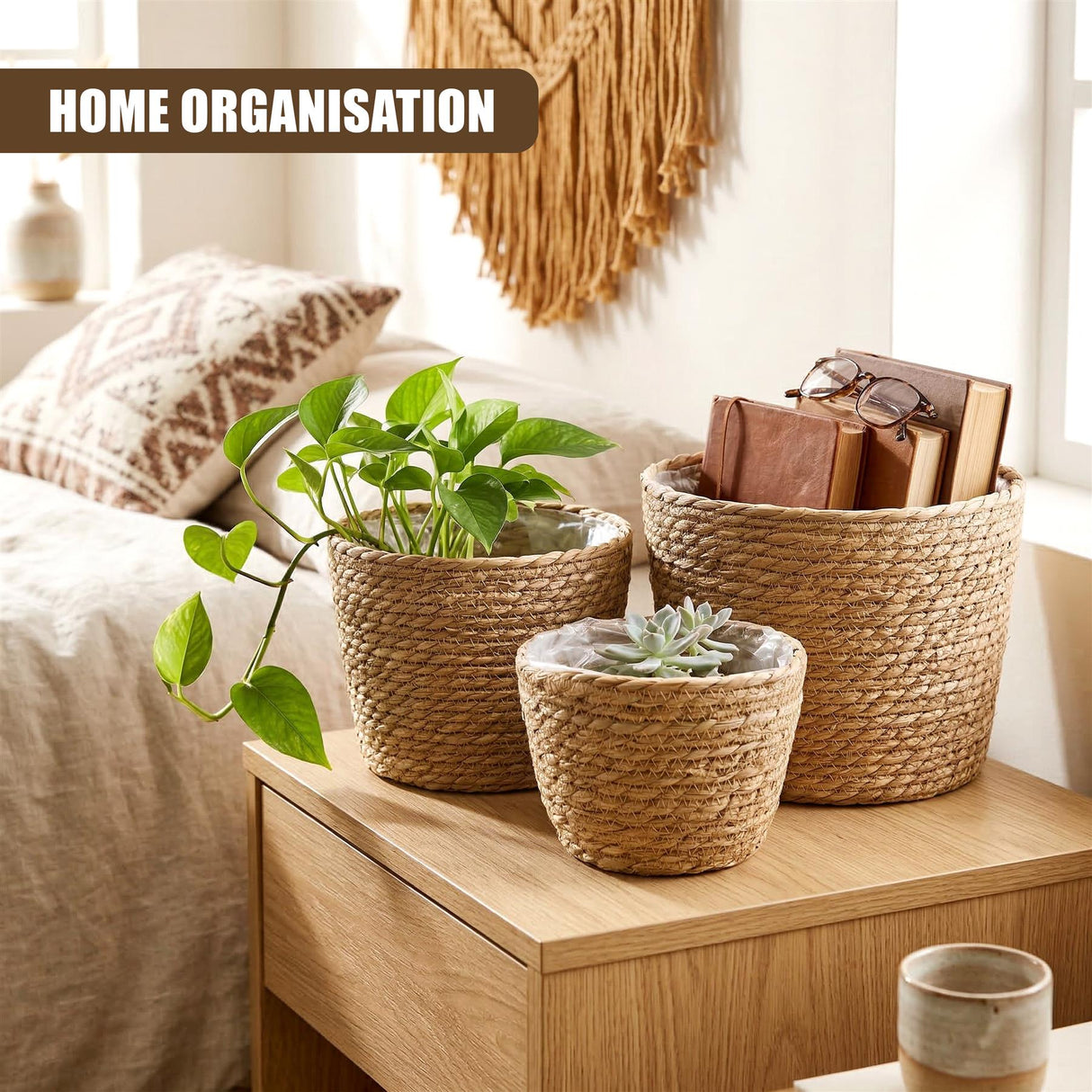 Three woven wicker baskets displaying plants, succulents, and stacked books on a wooden surface.