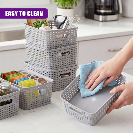 A hand cleans a modular gray storage basket filled with kitchen supplies and tools.