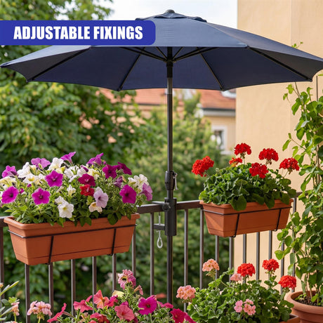 A metal clamp attaches the dark parasol pole securely to the wrought iron railing.