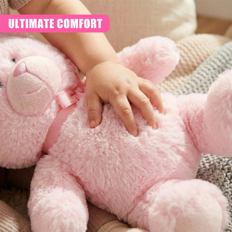 A plush pink teddy bear with a soft, fuzzy texture and a cute face, with a child's hand gently touching its back. - UKBuyZone