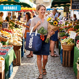 Woman carrying a bouquet and a dark blue cooler bag through a busy outdoor market.