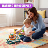 A woman sits on the floor with a young child, playing with a toy shopping set. The child holds a toy shopping cart, and the woman helps guide the child's hand to place a toy food item into the cart. The toy shopping set includes a cash register, play money, and various food and shopping items. The room is decorated with a colorful rug, bookshelf, and couch in the background. - UKBuyZone