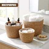 Wicker storage set displaying soap bottles and stacks of rolled towels on a white surface.