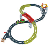 A detailed toy train track set with multiple loops, an elevated red segment, and connecting blue tracks.