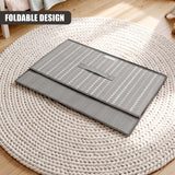Foldable gray storage box with heart pattern on lid, resting on a round woven rug