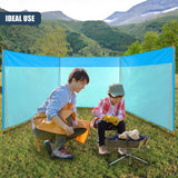 A man and child sit outside near a portable blue fabric privacy screen enclosure.