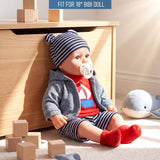 A doll is shown wearing a striped hat, grey cardigan, red and blue striped shorts, and red socks.