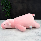 A pink pillow shaped like a pig with an eye tag on its ear.