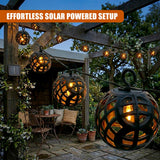 Multiple dark, spherical caged lanterns are strung across a wooden outdoor patio arbor.