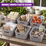 A set of woven gray baskets containing soil, plant tags, tools, pots, and smooth decorative pebbles.