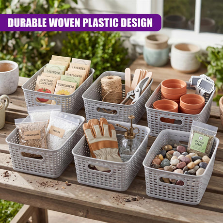 A set of woven gray baskets containing soil, plant tags, tools, pots, and smooth decorative pebbles.
