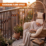 Rattan chair and solar string lights decorate a balcony surrounded by potted greenery.