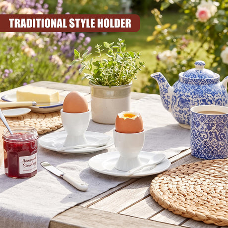 Set of 4 white ceramic egg cups with spoons on a garden table with tea and jam
