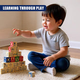 A child sits on a rug, pointing at wooden blocks featuring letters, numbers, and various objects.