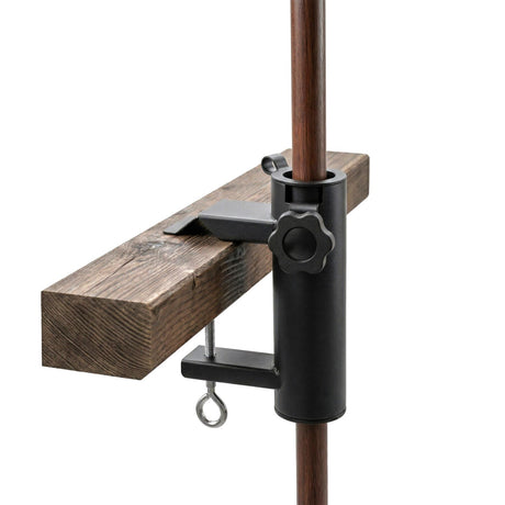 Black metal clamp attaches to a vertical pole, gripping a rustic wooden support piece.
