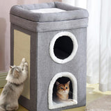 A small, gray cat house with a white interior and a peek-through window. Cats in the background are looking into it. - UKBuyZone
