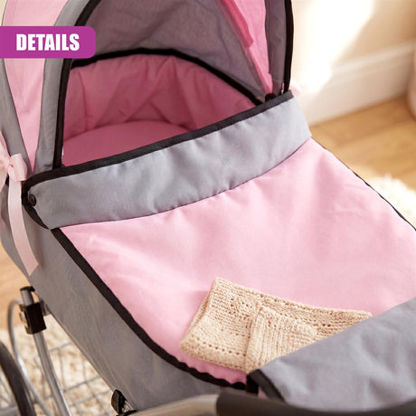 Gray and pink miniature pram interior with a cream crocheted blanket visible inside the carriage.