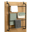 A metal towel rack hangs on wood, displaying five folded towels: white, green, cream, and gray.