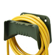 Dark green hose holder mounted on a wall, positioned above a coiled yellow garden hose.