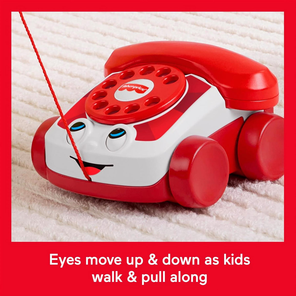 A red and white toy telephone with wheels, blue eyes, and a large domed head.