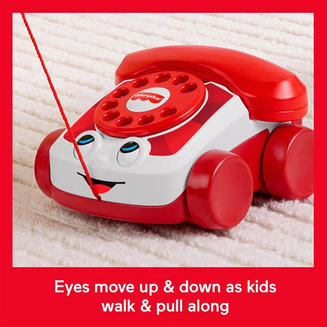 A red and white toy telephone with wheels, blue eyes, and a large domed head.