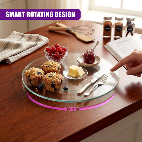 Glass turntable displays muffins, berries, butter, jam, and cutlery arrangement on wood.