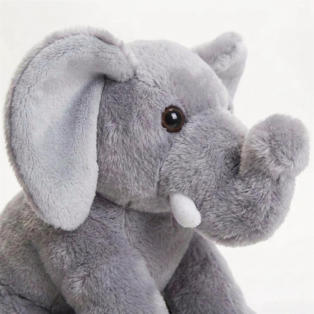 Gray plush elephant toy with large floppy ears and a visible, detailed trunk.