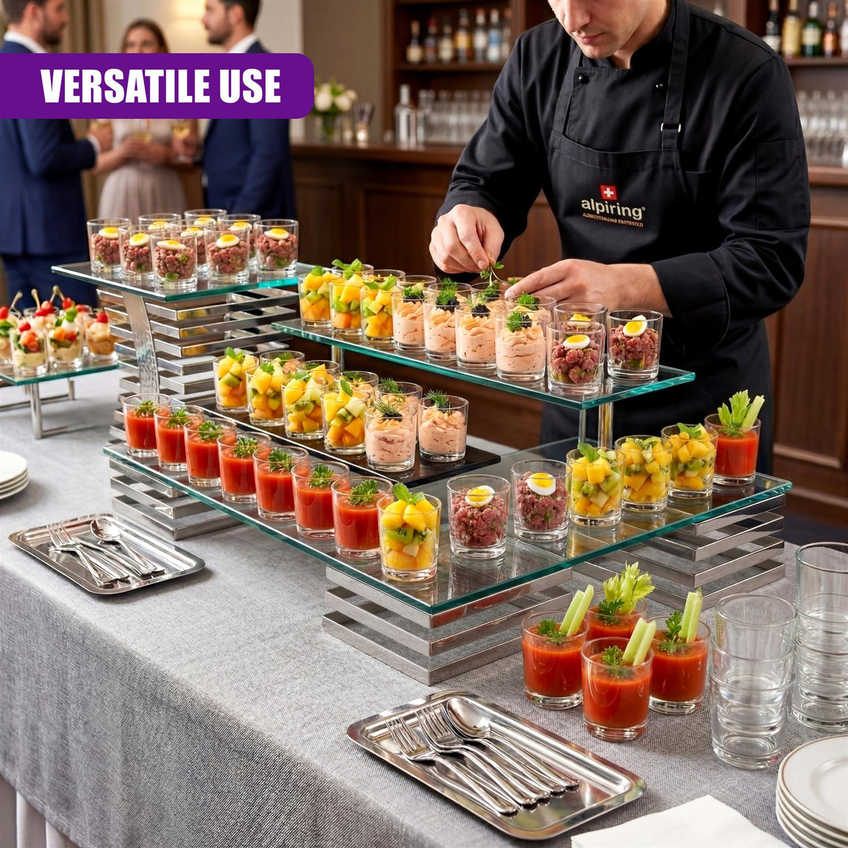 Dessert display featuring multiple mini servings in clear shot glasses arranged on tiered trays.