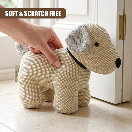 Crocheted light tan dog figure with black nose and gray ears placed near a white door.