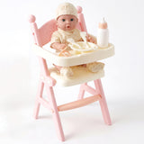 Pink high chair set containing a doll, bottle, and baby feeding accessories.