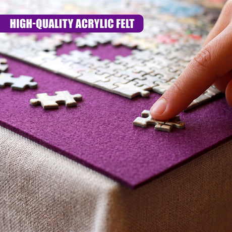 Close up of a hand pointing to puzzle pieces on a purple acrylic felt sheet.