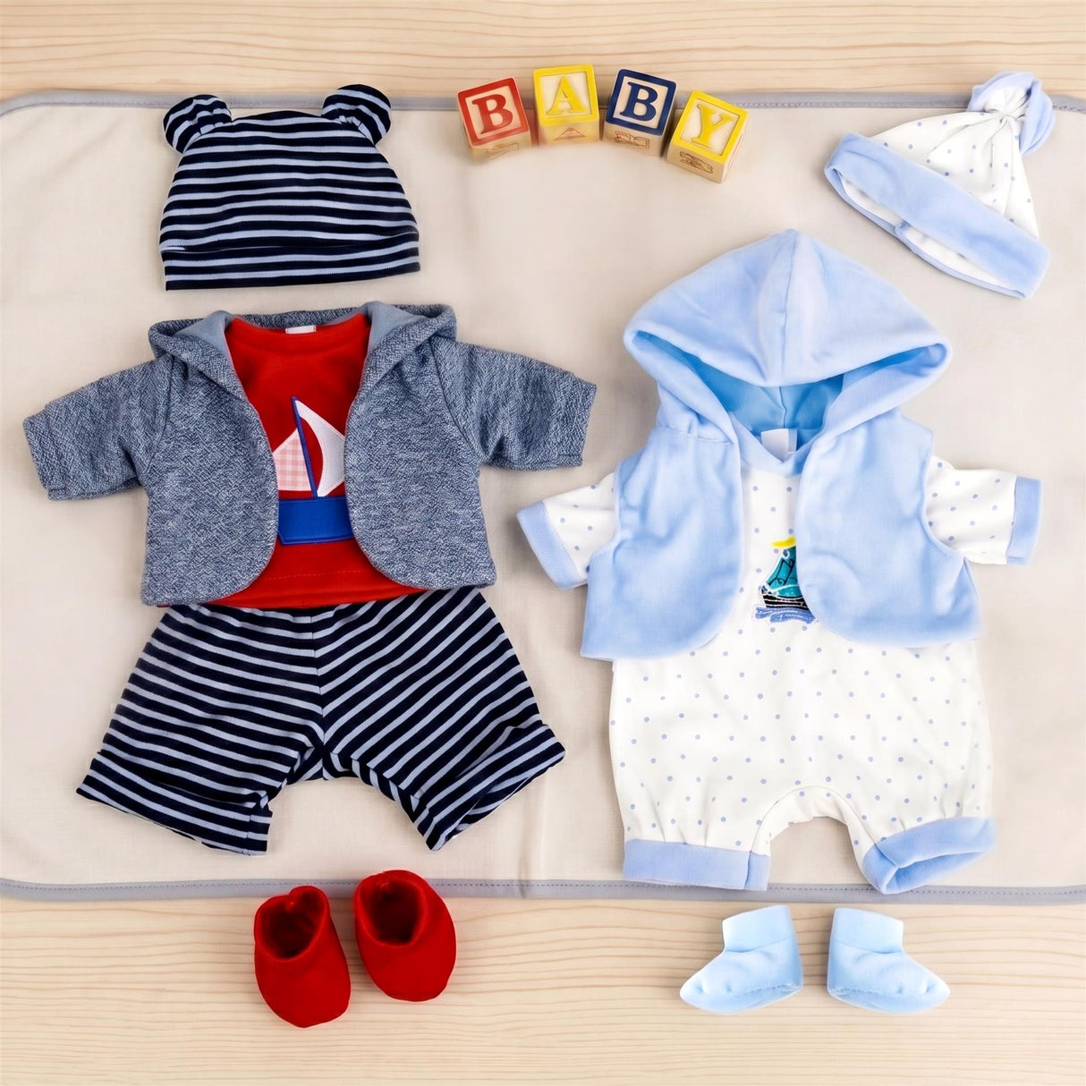 Two coordinating baby outfits are displayed, including striped pants, a polka dot onesie, and accessories.