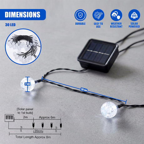 A solar panel connects to an outdoor string of clear, spherical LED lights.