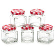 Five small, cubic glass jars are displayed with coordinating red and white checkered lids.