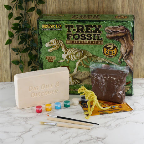 Fossil excavation kit shows a box, pink digging block, brown modeling material, and yellow dinosaur skeleton.