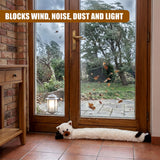 The cream cat draught excluder lies on the floor in front of the large glass double doors.