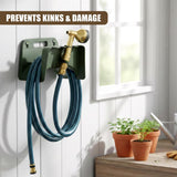A dark green wall mount supports a coiled blue garden hose and attached brass nozzle.