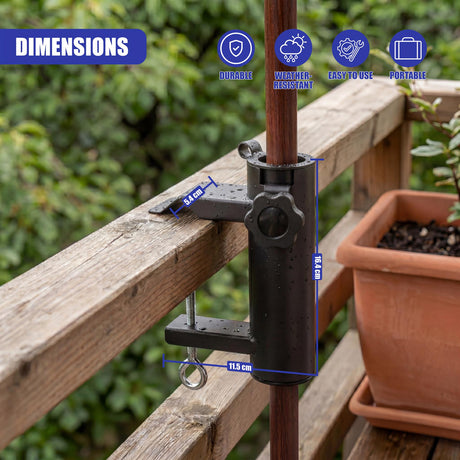 Black metal clamp grips a pole and attaches to a horizontal wooden railing.