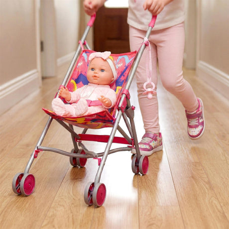 A pink baby buggy holding a doll, positioned on a hardwood floor, handled by a person.