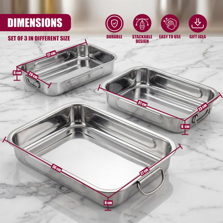 Three stainless steel rectangular roasting trays of varying sizes are displayed on a surface.