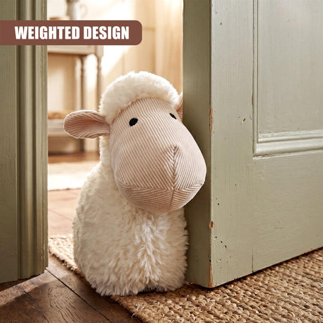 Fluffy, light-colored sheep door stopper placed against a pale green wooden door frame.