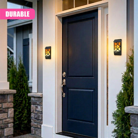 Dark blue front door framed by two illuminated, amber-glass lantern-style wall sconces.