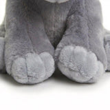 Detailed view of the soft, gray plush feet of an elephant stuffed toy.