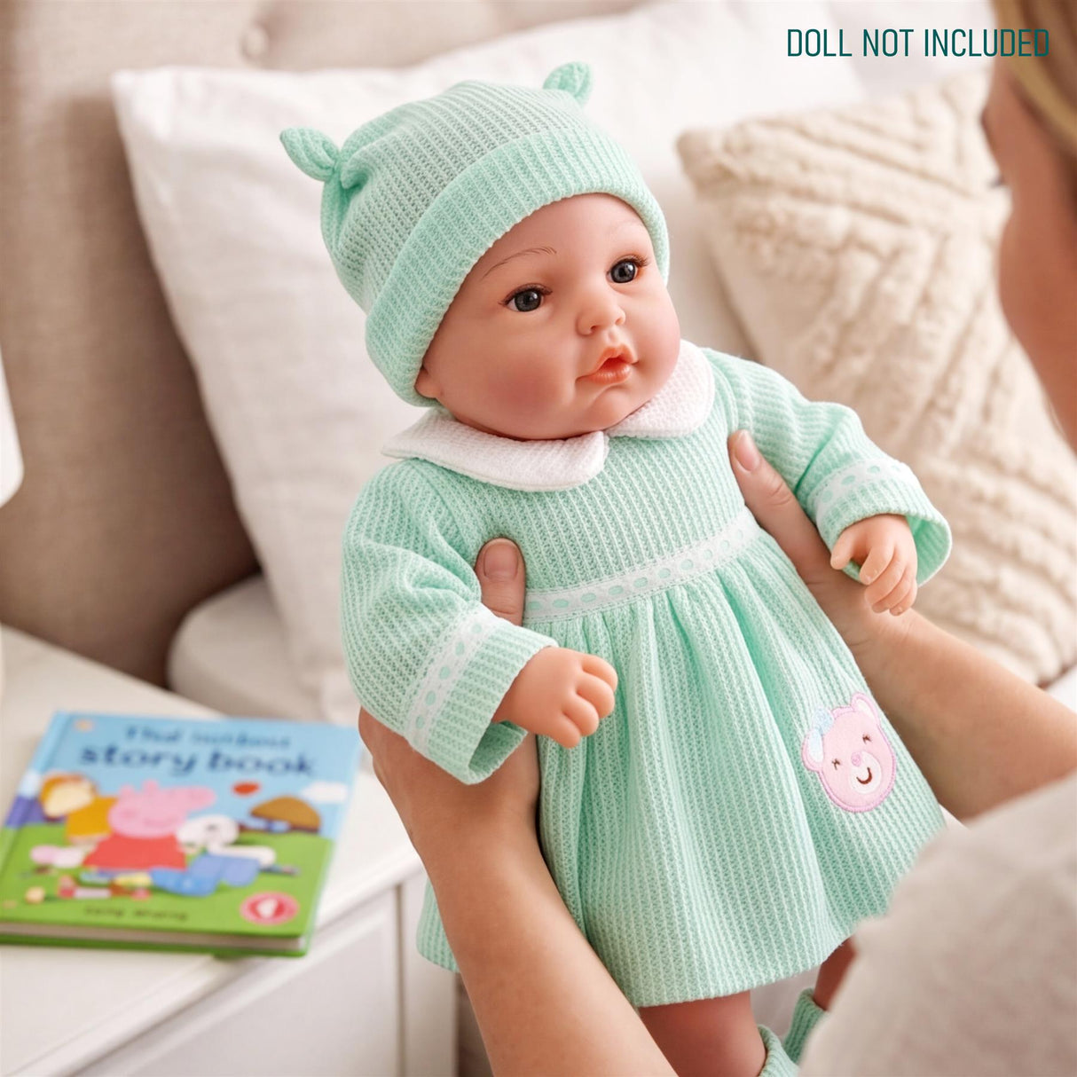 Mint green baby doll outfit including a hat and dress with white and pink accents.