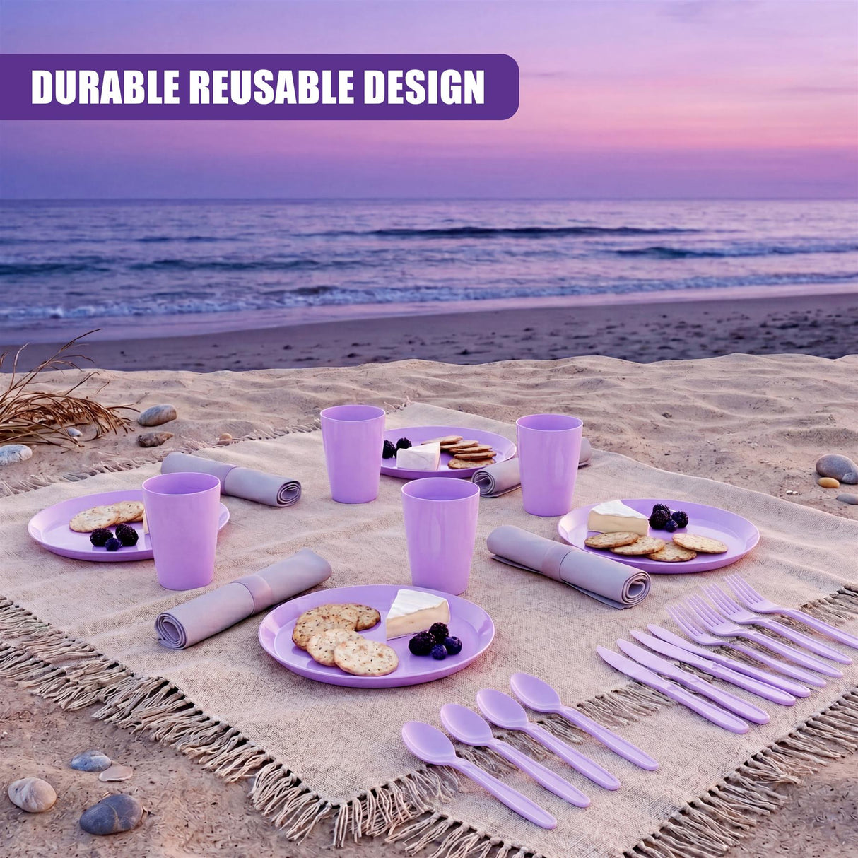 Purple picnic items, including cups, plates, and silverware, are laid out on a textured blanket on the sand.