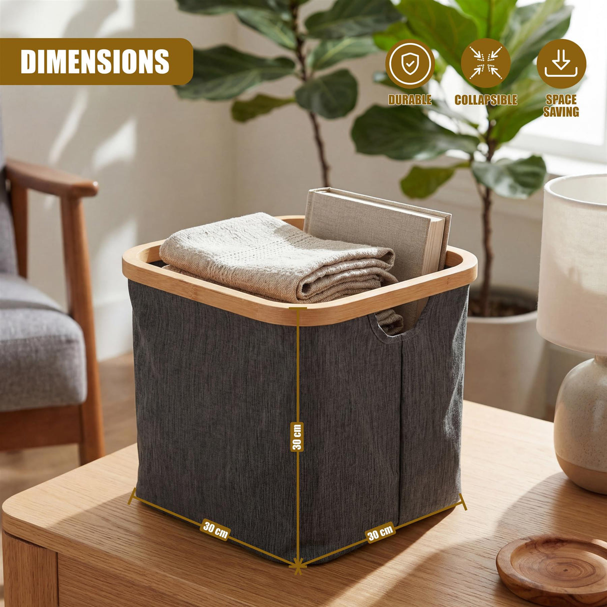 Gray fabric hamper with handles, filled with towels, resting on a light wooden surface.