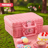 Pink woven picnic basket displayed on a red checkered cloth near sweets and teacup.
