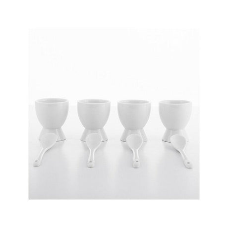 Four identical white egg cups with spoons.