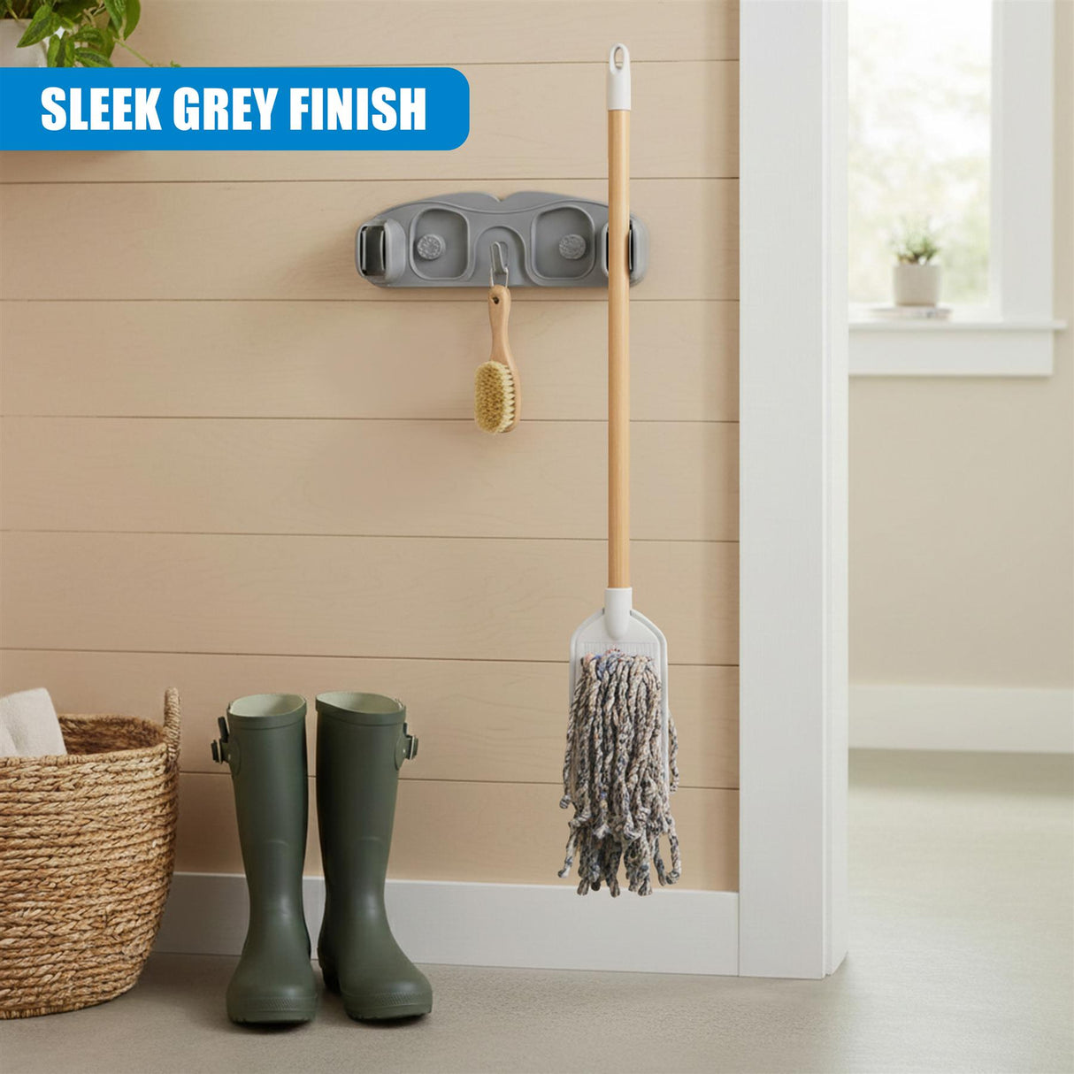 Wall mounted mop and broom holder with mop head and small brush tool.